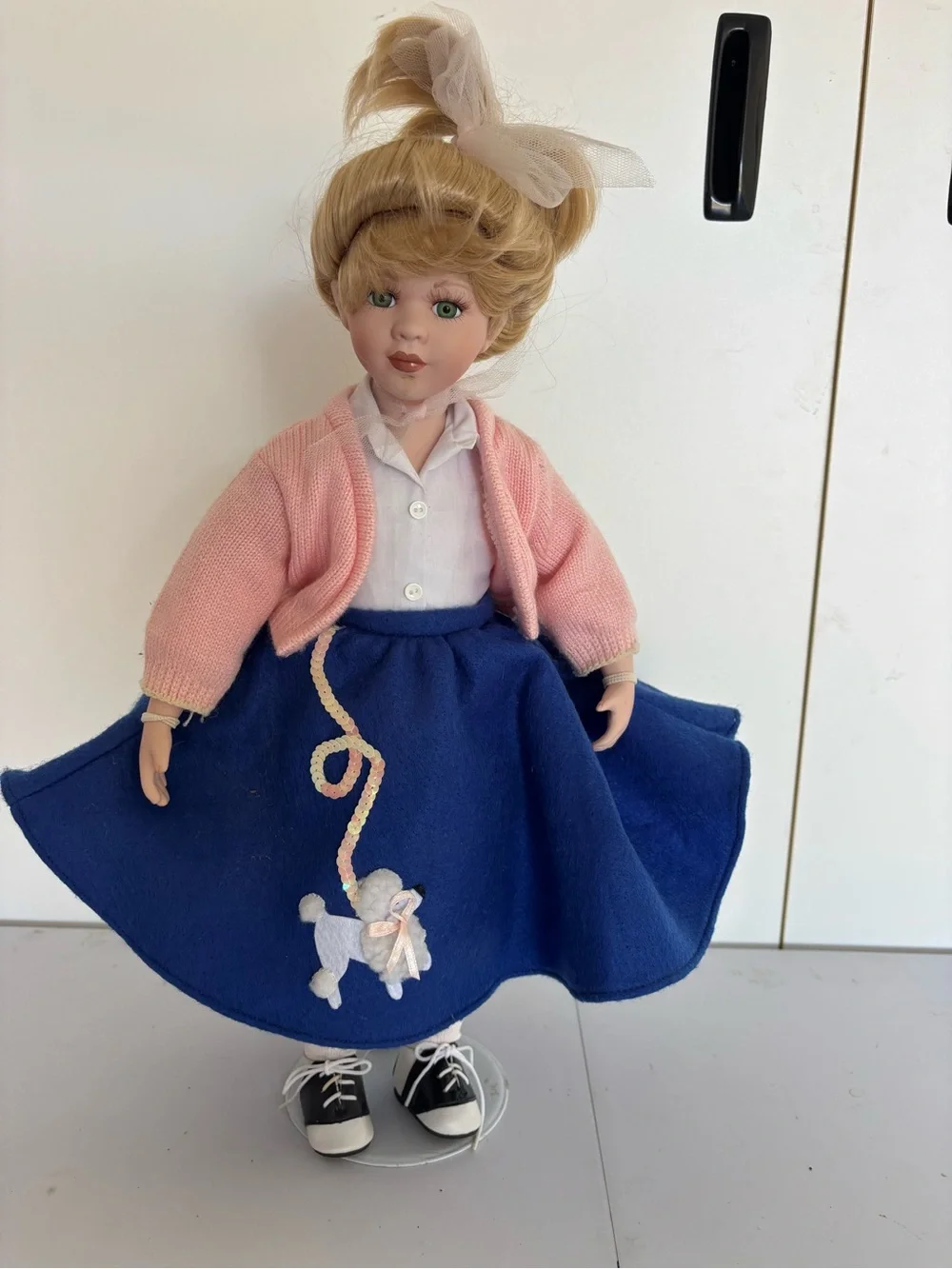 Porcelain Blonde Doll in Pink Cardigan and Blue Skirt